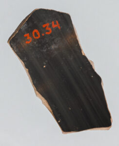 Alternate view of Fragment of a terracotta cup featuring red figure painting of a flying figure.