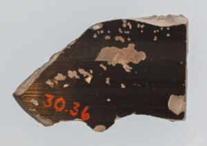 Alternate view of Fragment of a terracotta vase with black-figure painting, revealing part of a horse's head.