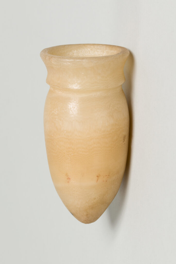 Small, white alabaster vessel shaped like a bullet.