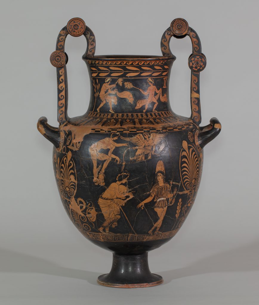 An ancient, ornately-decorated, two-handled, greek vase. The black background is decorated wth assorted brownish-orange floral motifs, male youths,satyrs and a winged figure on the base and neck.