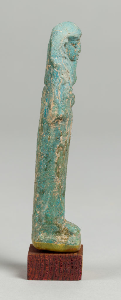 Alternate view of A green tinted ancient Egyptian figurine carved into the shape of a mummy.