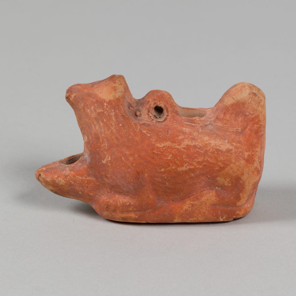 Alternate view of Red terracotta lamp shaped like a dog's head.