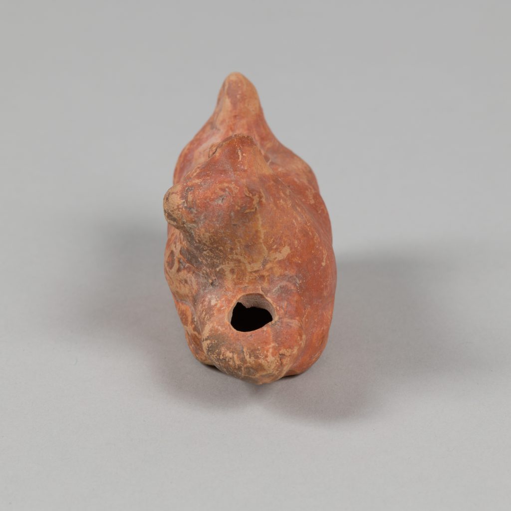 Alternate view of Red terracotta lamp shaped like a dog's head.