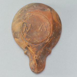 Alternate view of Red terracotta, pear-shaped piece with a scallop shell carved in the center.