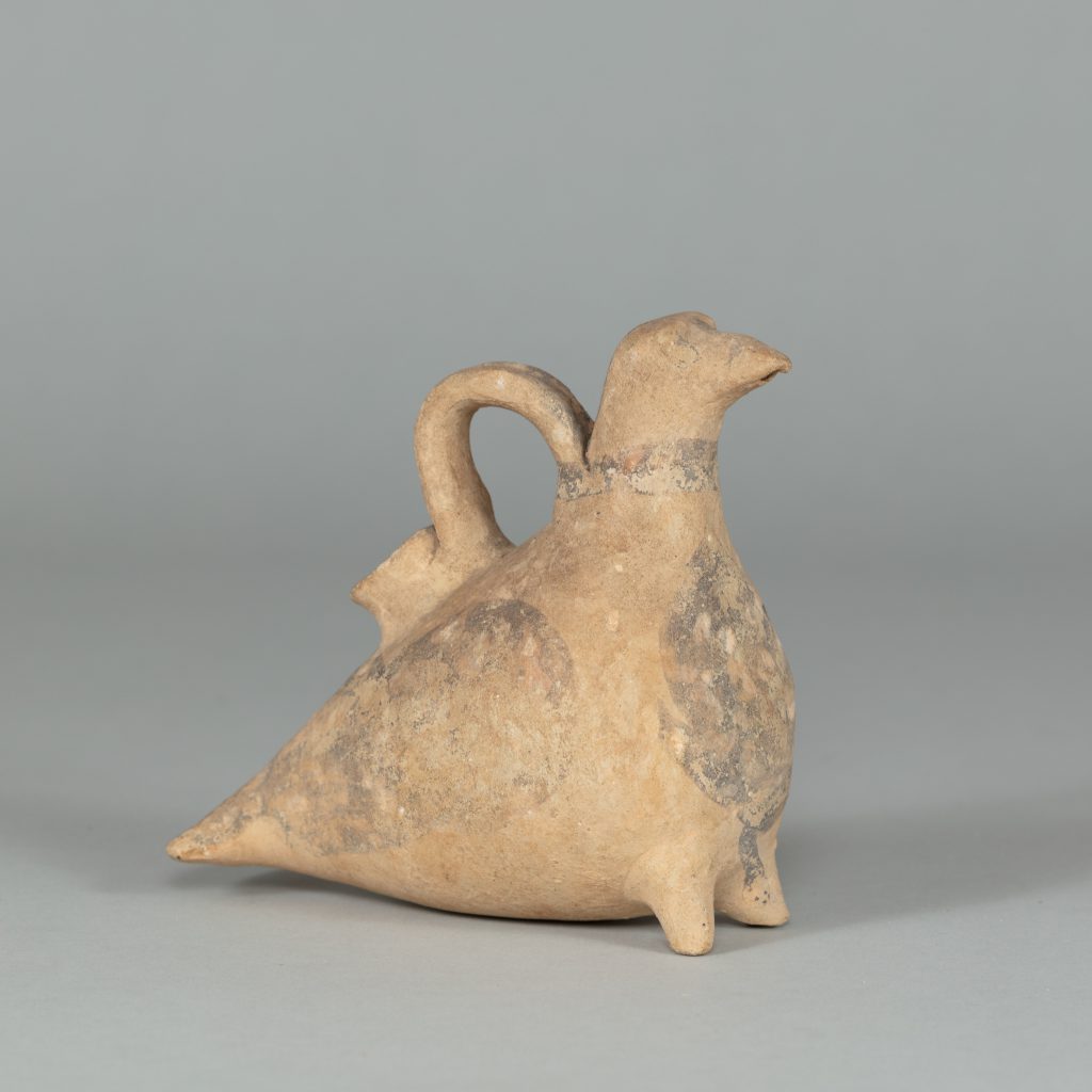 Bird-shaped terracotta vessel with feet and one small handle on its back.