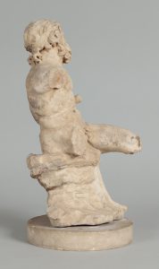 Alternate view of Small, white marble statue of a seated satyr, its arms and legs missing.