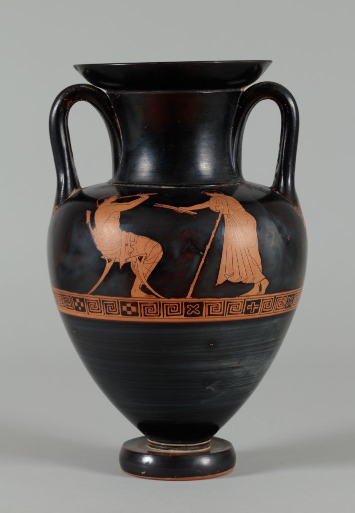 Black terracotta vessel with two handles and red-figure painting depicting a youth playing a flute while another figure observes.