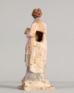 Alternate view of Painted terracotta statue of a woman with red hair, gather her pink and gray robe into her arms.