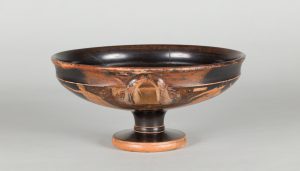 Alternate view of Low, black terracotta cup with two handles and red-figure painting depicting a mythological scene.