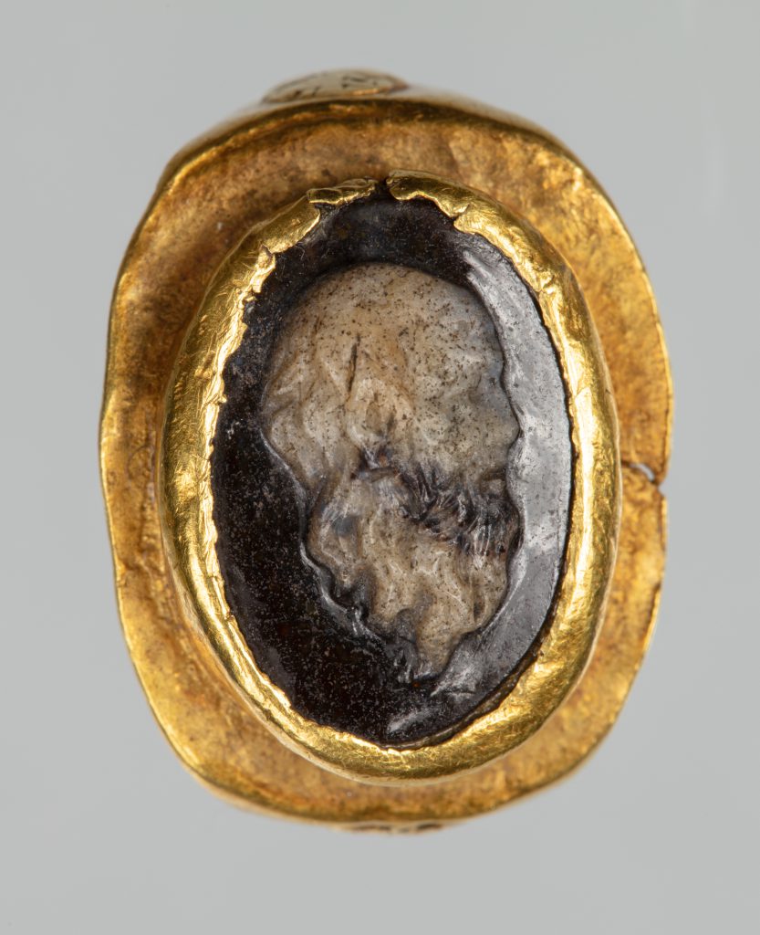 Gold ring with a black and white sardonyx cameo in its center.
