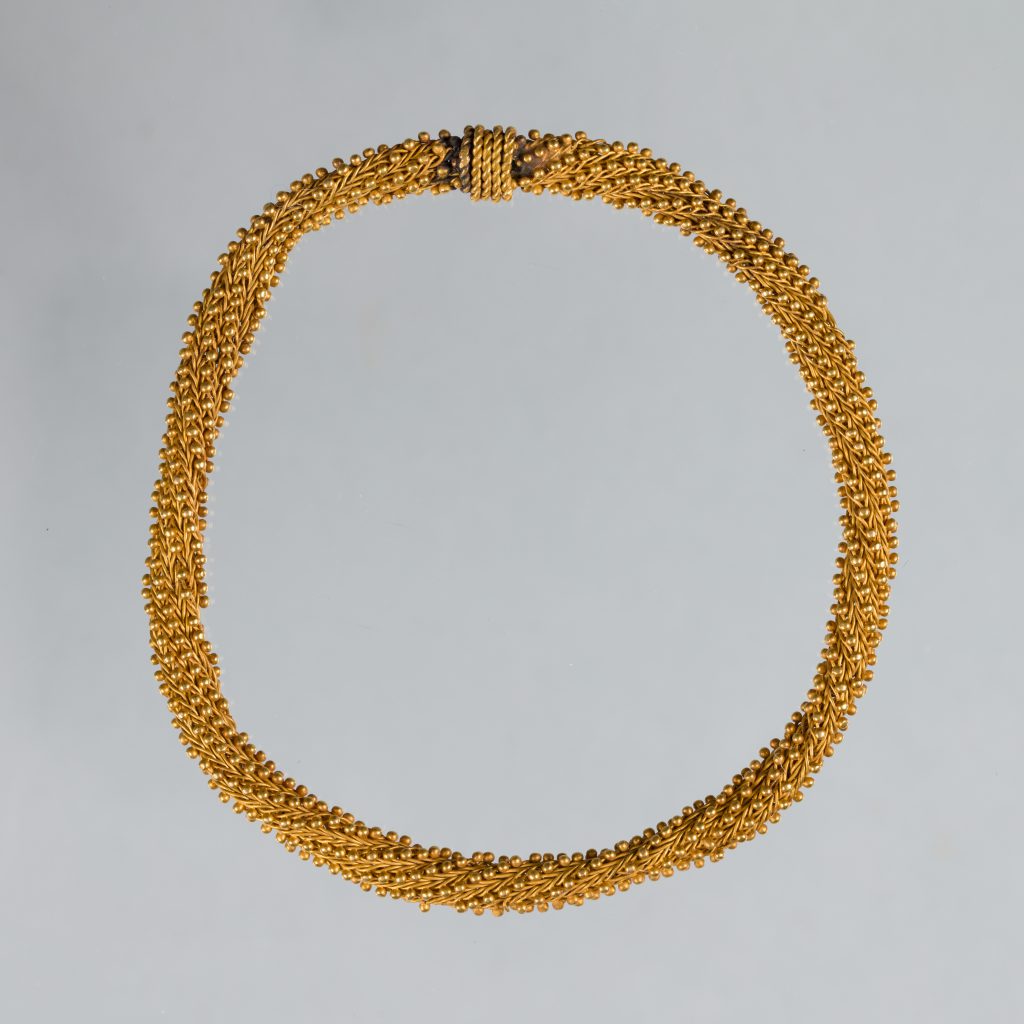 Intricate, gold cable-woven bracelet.