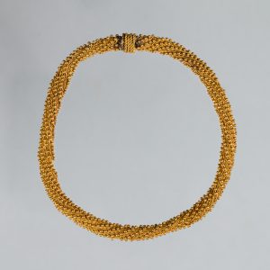 Intricate, gold cable-woven bracelet.