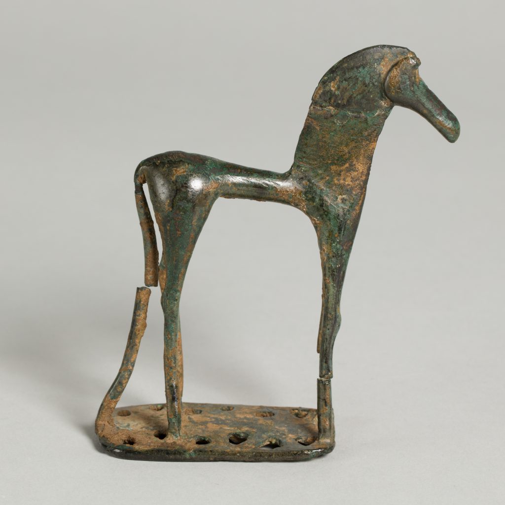 Bronze figurine of a horse mounted on a small base, its back leg broken in one spot.
