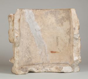 Alternate view of White, marble fragment of an urn with figural carvings in relief.