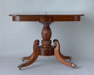 Alternate view of Mahogany card table with an ornatiely carved base.