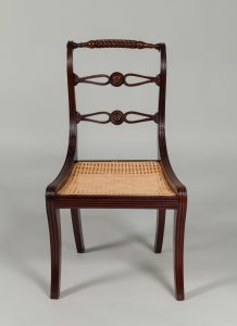 Alternate view of Dark mahogany chair with a woven cane seat.