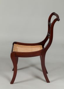 Alternate view of Dark mahogany chair with a woven cane seat.