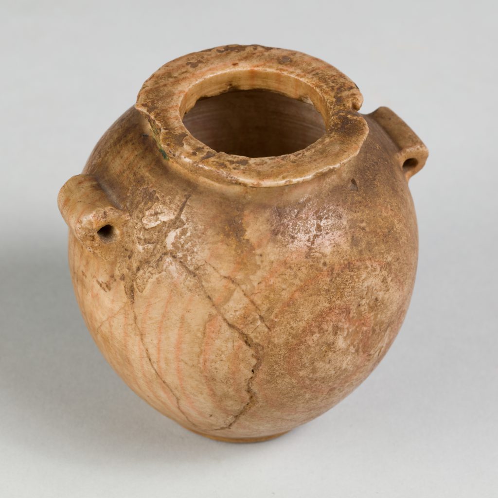 Orange-tinted jar with lug handles and subtle rings visible across its cracked surface.