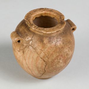 Orange-tinted jar with lug handles and subtle rings visible across its cracked surface.