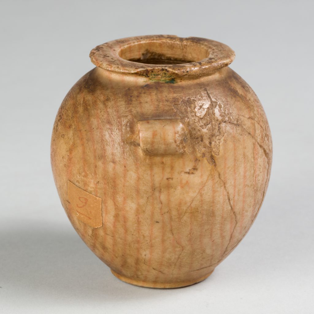 Alternate view of Orange-tinted jar with lug handles and subtle rings visible across its cracked surface.