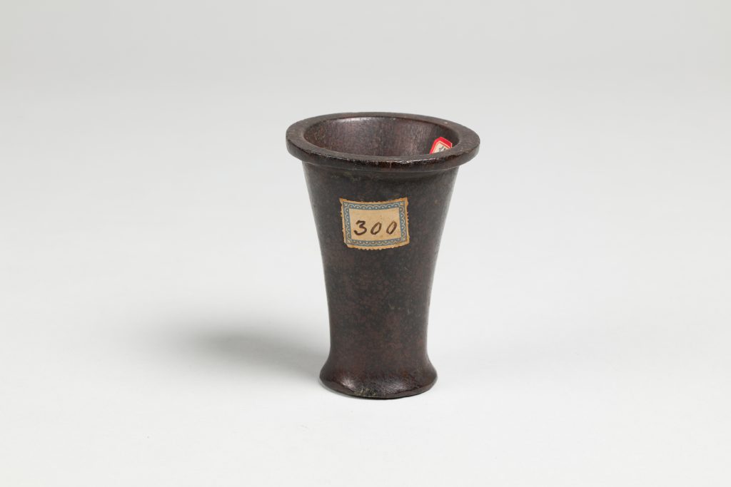 Small black cone-shaped jar with the number 300 labeled on the surface.