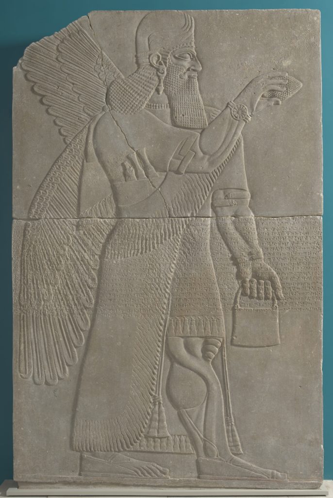 Sculptural relief panel featuring a winged man with a long beard and a helmet, holding a small bucket.