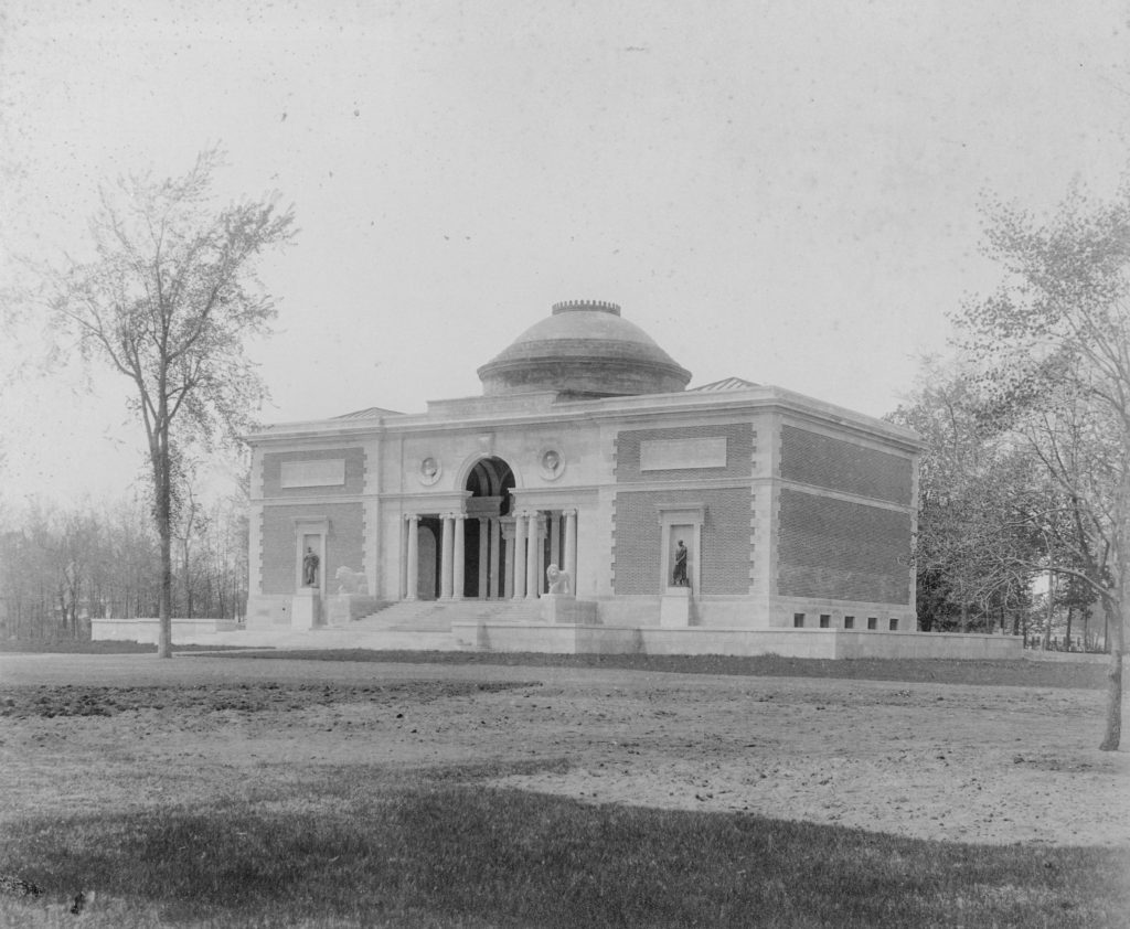 Black and white photo of the classical-style museum building with columns in the front and a domed rotunda roof in its center.